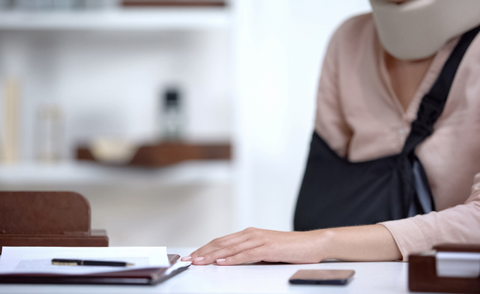 Flying Needle Acupuncture and Bodywork – Motor Vehicle Accidents – Workers Compensation injured person dealing with insurance paperwork